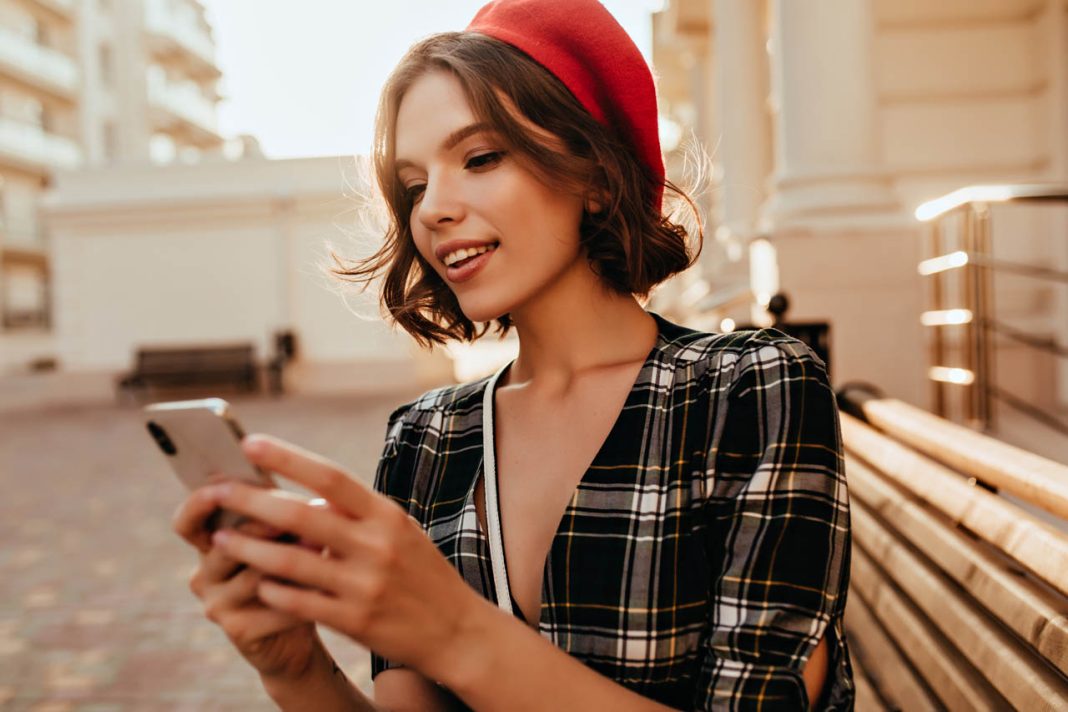 Winsome,Elegant,Girl,Texting,Message,In,Autumn,Day.,Debonair,Short-haired